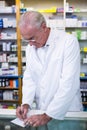 Pharmacist writing prescriptions for medicines Royalty Free Stock Photo