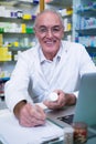 Pharmacist writing prescriptions for medicines Royalty Free Stock Photo