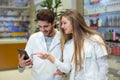 Pharmacists using digital tablet while checking medicine Royalty Free Stock Photo