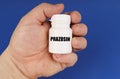 On a blue background in the hands of a man is a white jar with the inscription - Prazosin