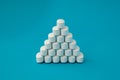 pharmacology medical concept pyramid of white pills tablets drugs on cyan surface with copyspace Royalty Free Stock Photo