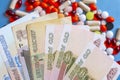 Pharmacy background. Business finance. Russian money and pills on blue backgrouind.