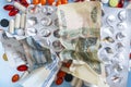 Pharmacy background. Business finance. Russian money and pills on blue backgrouind.