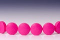Pharmacy background. queue of pink pills. Reflection of drug. Pharmaceutical Royalty Free Stock Photo