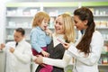 Pharmacy chemist, mother and child in drugstore