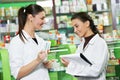 Pharmacy chemist women in drugstore