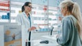 Pharmacy Drugstore Checkout Cashier Counter: Female Pharmacist Explains Use and Manual for