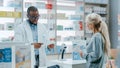 Pharmacy Drugstore Checkout Counter: Black Male Pharmacist Explains Use and Manual for Prescription Royalty Free Stock Photo