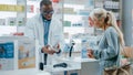 Pharmacy Drugstore Checkout Counter: Black Male Pharmacist Explains Use and Manual for Prescription Royalty Free Stock Photo