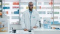 Pharmacy Drugstore Checkout Counter: Portrait of Handsome Professional Black Male Pharmacist Wearing Royalty Free Stock Photo