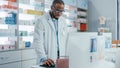 Pharmacy Drugstore Checkout Counter: Portrait of Professional Black Pharmacist Working on Computer Royalty Free Stock Photo