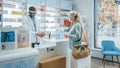 Pharmacy Drugstore Checkout Counter: Professional Black Pharmacist Wearing Face Shield Sells