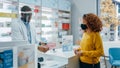 Pharmacy Drugstore Checkout Counter: Professional Black Pharmacist Wearing Face Shield Sells