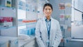 Pharmacy Drugstore: Portrait of Beautiful Asian Female Pharmacist Wearing White Lab Coat, Looks at Royalty Free Stock Photo