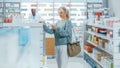 Pharmacy Drugstore: Portrait of a Beautiful Senior Woman Choosing to Buy Medicine, Drugs, Vitamins Royalty Free Stock Photo