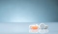 Pharmacy drugstore product. Pile of orange and white tablets pill on gradient background. Different size and shape tablets pills. Royalty Free Stock Photo