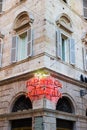 Pharmacy neon sign in the old town of Ascoli Piceno, Italy