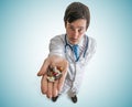 Pharmacy and Pharmacology concept. Doctor holds many pills in hand. Royalty Free Stock Photo