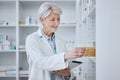 Pharmacy, senior woman and tablet with pills, inventory and checking stock with connection, smile and research. Old Royalty Free Stock Photo