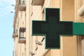 Pharmacy sign on the street. Green pharmacy sign.