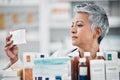 Pharmacy, stock and senior woman pharmacist with box, pills and medication, reading and checking information. Elderly Royalty Free Stock Photo
