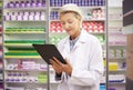 Pharmacy, tablet and pharmacist woman for product management, stock research and inventory data app. Digital technology Royalty Free Stock Photo