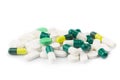 Green capsules and white antibiotic pills. Royalty Free Stock Photo