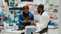 Pharmacy worker recommending medication to woman Royalty Free Stock Photo