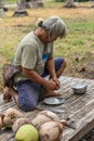 Phase four: scraping meat out of harvested coconut on Ko Samui Island, Thailand