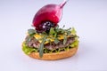 Phased assembly of a hamburger on a light background13