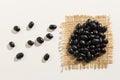 Black Turtle Bean legume. Close up of grains spreaded over white Royalty Free Stock Photo