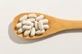 Navy Bean legume. Nutritious grains on a wooden spoon on white b Royalty Free Stock Photo