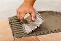 Phases of installing ceramic floor tiles - the adhesive Royalty Free Stock Photo
