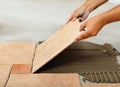 Phases of installing ceramic floor tiles - placing the tile Royalty Free Stock Photo