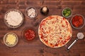 Phases of making a pizza - putting on the grated cheese Royalty Free Stock Photo