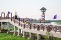 PHATTHALUNG, THAILAND- April 23: Unidentified tourists are walking on a bridge in Thale Noi Waterfowl Reserve on April 23, 2016 i
