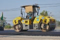 Zoom Back View Worker and Road Roller on Asphalt Road