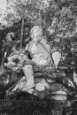 Black and White Portrait Marble Sun Wukong or Monkey King Statue on Stone and Baton Royalty Free Stock Photo