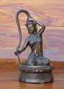 Closeup Goddess Statue of Phra Mae Thorani Isolated on Wooden Background