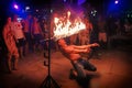 Phi Phi Island, Thailand, November 13, 2017: A merry youth people limbos under a bar of fire. Crowd partying in Phi Phi Royalty Free Stock Photo