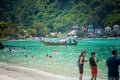 Phi Phi islands. Thailand. February 10, 2019: Happy tourists swimming and enjoy sandy beach and sunny day at the tropical island. Royalty Free Stock Photo