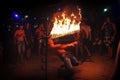 Phi Phi Island, Thailand, November 13, 2017: A merry youth people limbos under a bar of fire. Crowd partying in Phi Phi