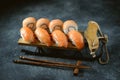 Philadelphia homemade sushi rolls and nigiri sushi with wild salmon on decorative sleigh, christmas background.