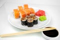 Philadelphia maki rolls and eel unagi maki with soy sauce, pink ginger, wasabi on white background, asian food, japanese sushi set Royalty Free Stock Photo