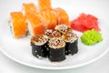 Philadelphia maki rolls and eel unagi maki with soy sauce, pink ginger, wasabi on white background, asian food, japanese sushi set Royalty Free Stock Photo