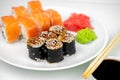 Philadelphia maki rolls and eel unagi maki with soy sauce, pink ginger, wasabi on white background, asian food, japanese sushi set Royalty Free Stock Photo