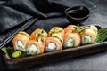 Philadelphia maki sushi with salmon, prawn, avocado, cream cheese. Sushi roll menu. Black background. Top view Royalty Free Stock Photo