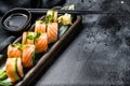 Philadelphia maki sushi with salmon, prawn, avocado, cream cheese. Sushi roll menu. Black background. Top view. Copy space Royalty Free Stock Photo