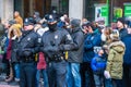 Two Philadelphia Police officers stand in front of crowd of spectators on Broad Street during the New Years Day Mummers Parade