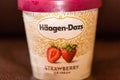 Container of Haagen-Dazs ice cream in strawberry flavor.